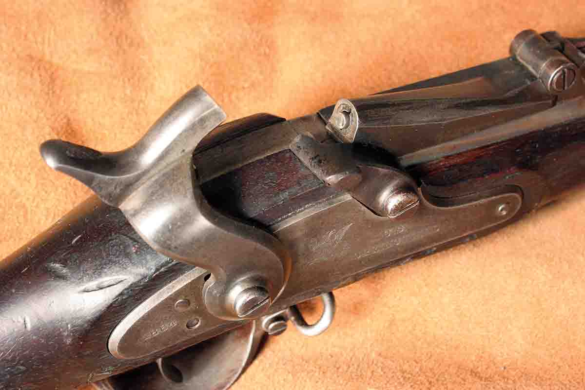 The breechblock contains a long, angled firing pin so the rifle can be fired with the original caplock hammer.